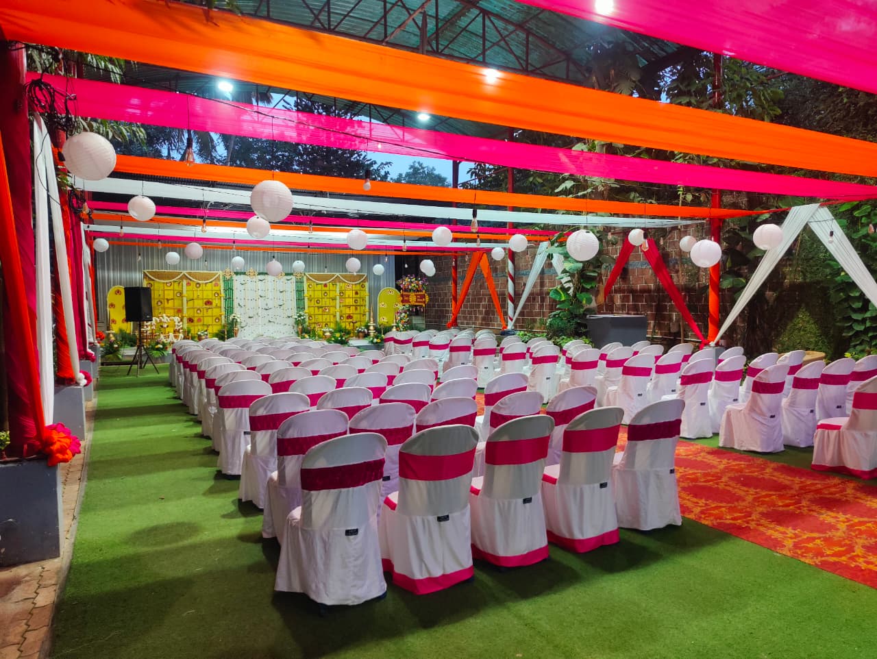 Outdoor reception stage with floral styling at Pergola.