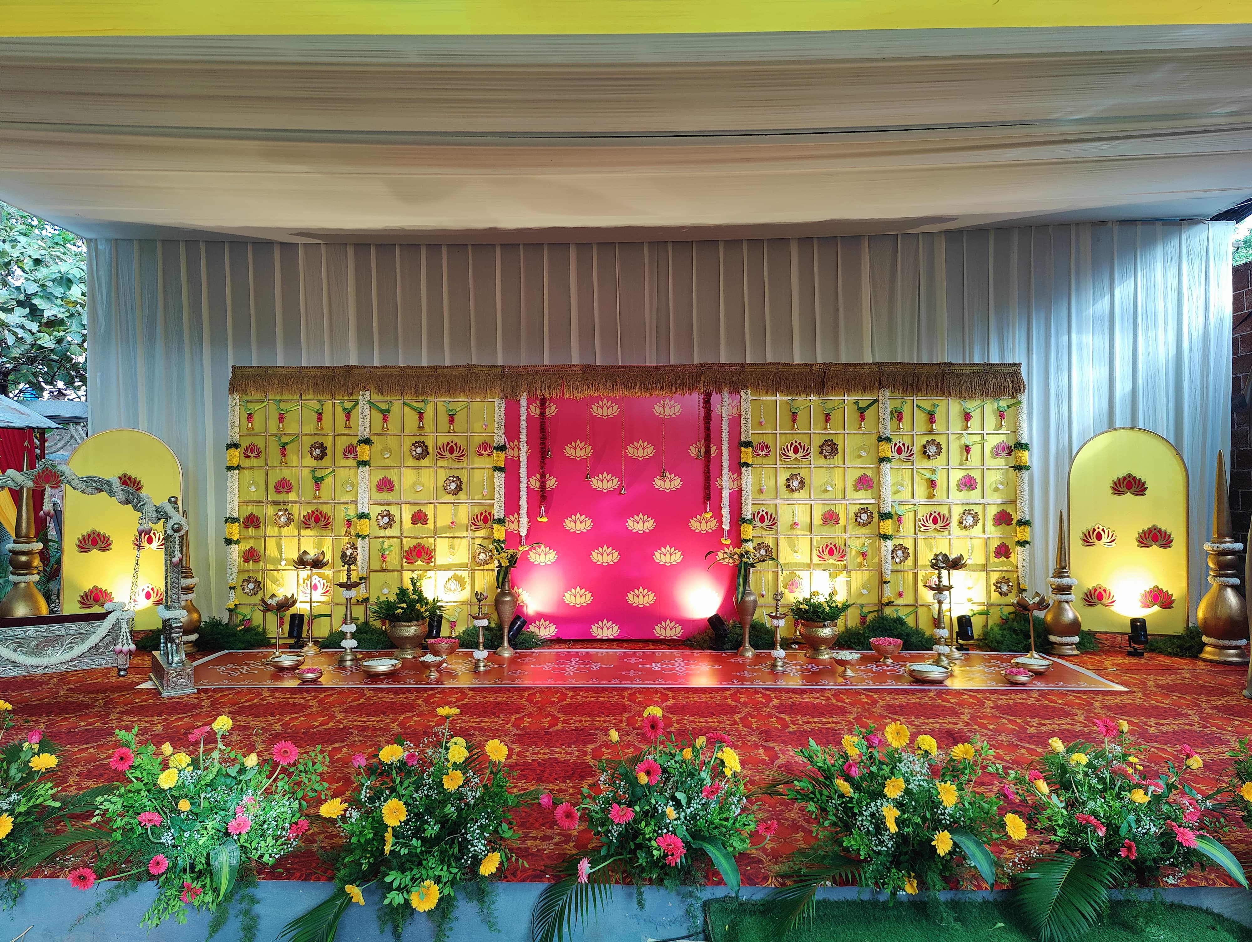 Pergola ballroom styled with ivory aisle and glowing floral stage.